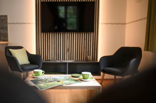 a living room with two chairs and a coffee table at Haus Sternenhimmel in Oberammergau