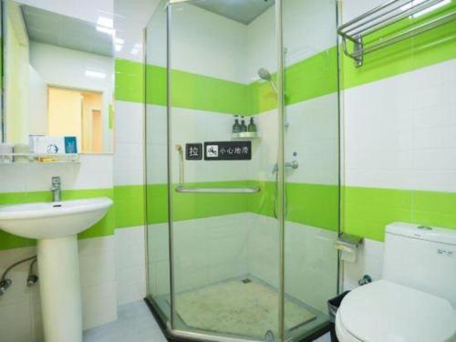 a bathroom with a shower and a toilet and a sink at 7 Days Inn Chongqing Beibei New District Light Rail Station in Huangjuezhen