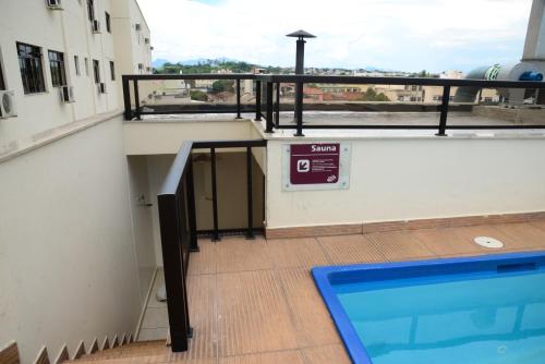 a swimming pool on top of a building at River Park Hotel in Resende