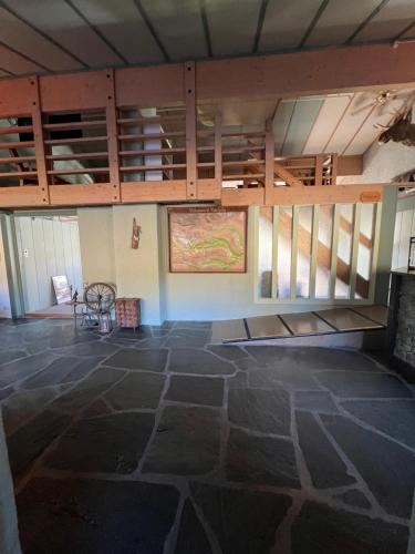 an empty room with a stone floor and wooden cabinets at Vats Fjellstue in Ål