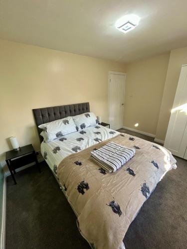 a bedroom with a bed with a blanket on it at Cosy nook apartment in Cayton
