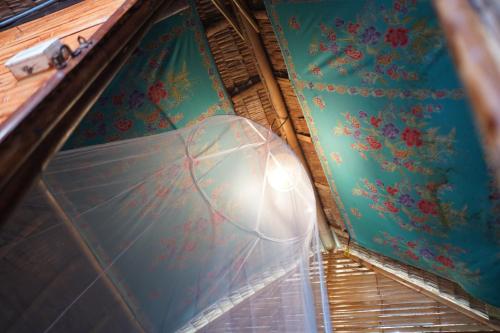 a room with a window with flowers on the wall at KRABI BAMBOO KINGDOM at AOLUEK PARADISE in Ao Luk