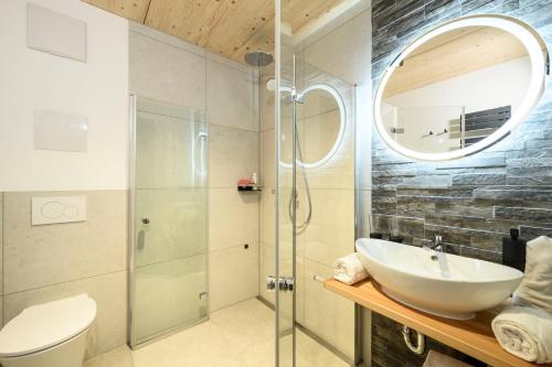 a bathroom with a sink and a glass shower at Haus Sternenhimmel in Oberammergau