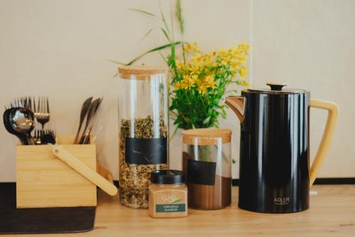 a table with a blender and containers of food at Clay House in Pāvilosta