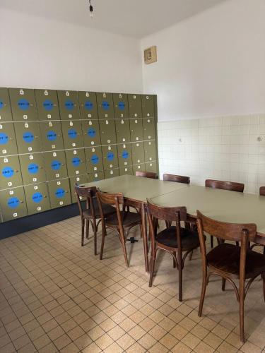 a conference room with a table and wooden chairs at NUMBR25 - self service & low budget Hotel in Graz