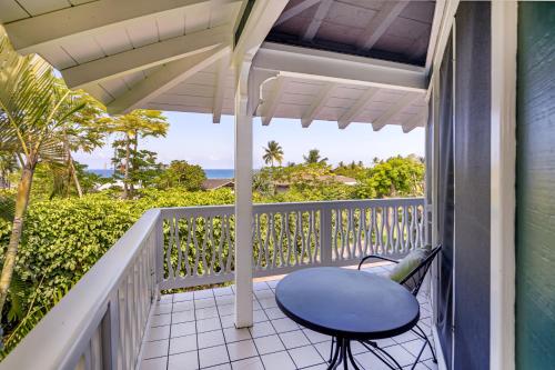 a balcony with a blue chair and a view of the ocean at Big Island Retreat - No Resort Fees in Kailua-Kona