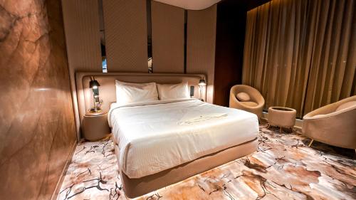 a hotel room with a bed and a chair at FHotels in Bengaluru