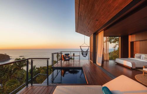 a bedroom with a view of the ocean at One&Only Mandarina in Lo de Marcos
