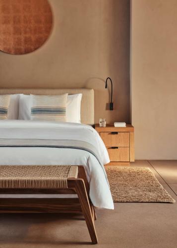 a bedroom with a large bed and a nightstand at One&Only Mandarina in Lo de Marcos