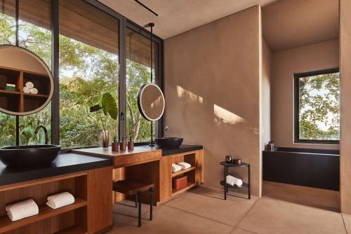 a bathroom with two sinks and a large window at One&Only Mandarina in Lo de Marcos