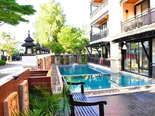 a swimming pool in front of a building at Puektian Seaview Studio Room in Ban Tanot Noi