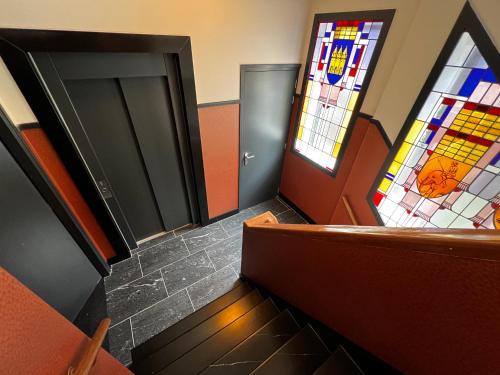 a room with a staircase with stained glass windows at Central Tilburg Apartments in Tilburg