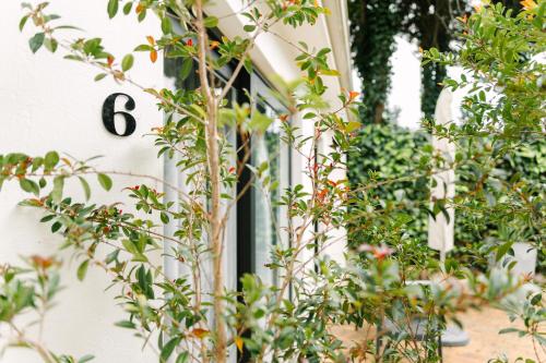 a window with the number on the side of a house at The Salene Hotel & Apartments in Stellenbosch