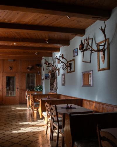 a dining room with wooden tables and chairs at Alpenhotel Edelweiss in Maurach