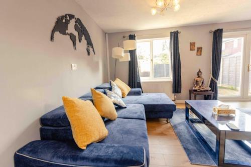 a living room with a blue couch and a table at 3 Bedrooms - Sleeps 8 - Wifi - 3 Car Parking in Andover