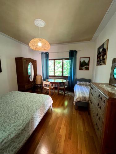 a bedroom with a bed and a table in it at Villetta la Fortezza in Radicofani