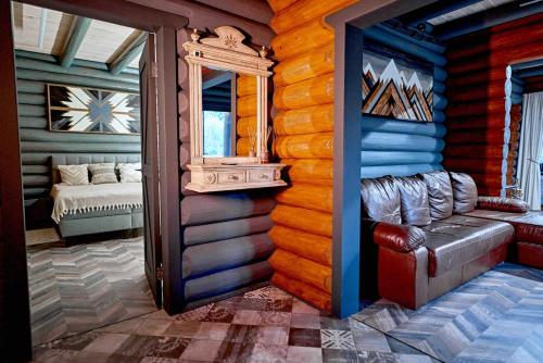 a room in a log cabin with a window and a couch at Koshara chalet - harmony in the midst of nature in Mriia