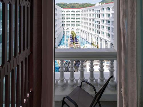 a balcony with a view of a building at Mövenpick Myth Hotel Patong Phuket in Patong Beach