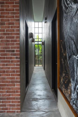 a hallway with a brick wall and a door at Chrisenbel Hideaway Retreat in Petaling Jaya