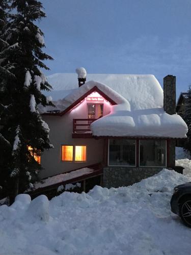 a house covered in snow with lights on it at Vila Carla Elena Ranca in Ranca