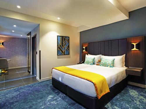 a bedroom with a large bed in a room at The Sebel Wellington Lower Hutt in Lower Hutt