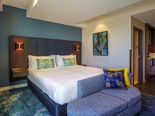 a bedroom with a large bed and a couch at The Sebel Wellington Lower Hutt in Lower Hutt