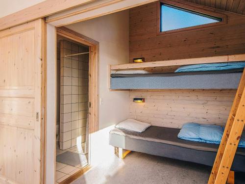 a room with two bunk beds and a window at Kaløvig Beach Holiday Centre in Rønde