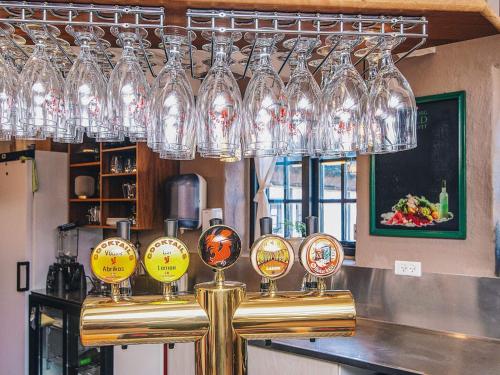 a bar with glasses on top of a counter at Kaløvig Beach Holiday Centre in Rønde
