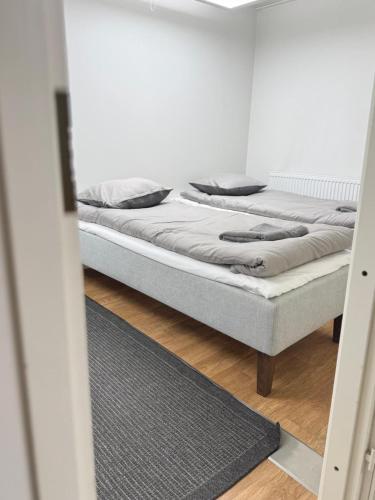 a bed sitting in a room with a mirror at Arctic Elf Apartment in Rovaniemi