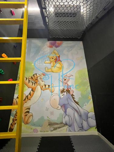 a floor in a room with a disney mural at Sunway GRID by SR Home in Kampong Pendas