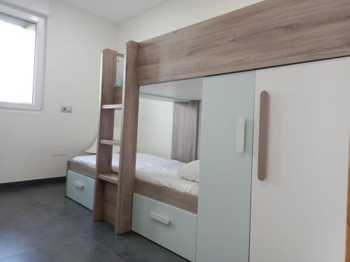 a bedroom with a bunk bed and a white cabinet at Abril 56 Villa&Suites in Oreña