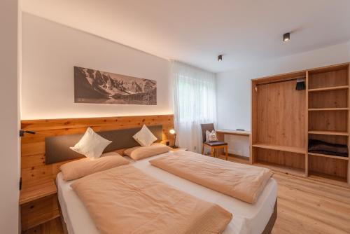 a bedroom with a large bed in a room at Haus Karin living in Brixen