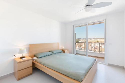 a bedroom with a bed and a large window at Bahía Mar Apartamento in Puerto de Mazarrón