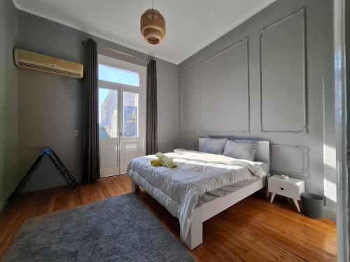 a bedroom with a bed and a large window at Cairo Backpacker Central Hostel in Cairo