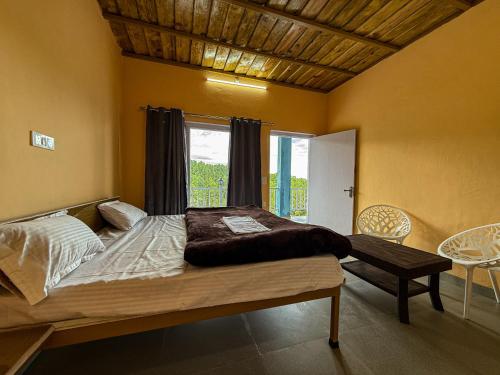 a bedroom with a large bed and a window at Datta's Heritage in Chaubattia