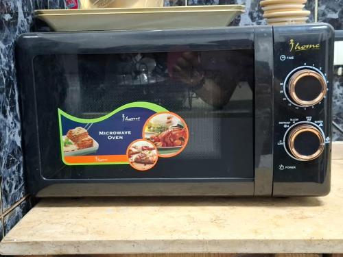 a black toaster oven with a sticker on it at Cairo Backpacker Central Hostel in Cairo