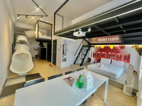 a living room with a white table and a couch at Sunway GRID by SR Home in Kampong Pendas