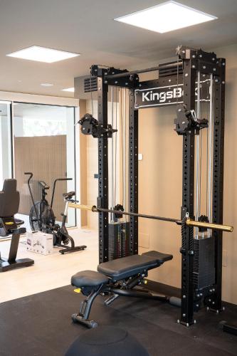 a gym with a squat rack and several exercise bikes at Hotel Relax Family & Spa in San Benedetto del Tronto