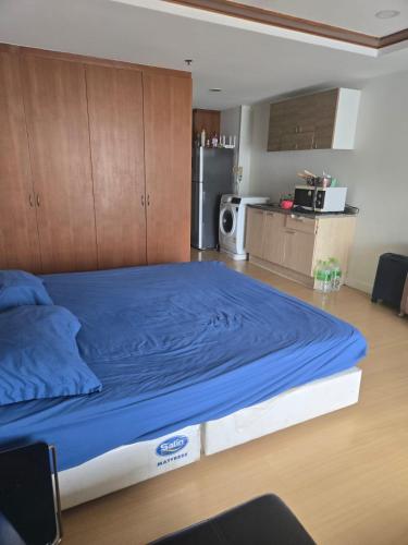 a large bed in a room with a kitchen at Studio apartment in Trendy Bankok in Bangkok