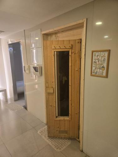 a kitchen with a wooden door and a refrigerator at Studio apartment in Trendy Bankok in Bangkok