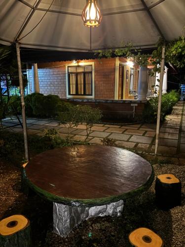 a table in front of a building with a tent at The Munroe Vibes Inn in Munroe Island