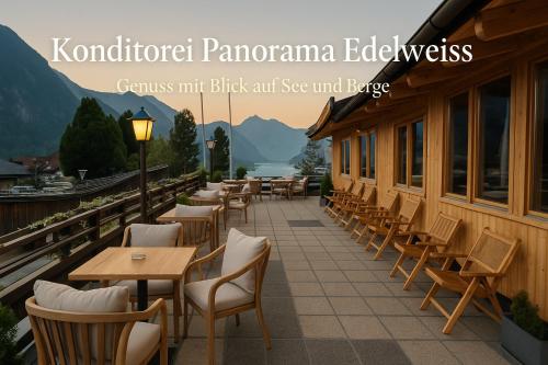 a restaurant with tables and chairs on a balcony at Alpenhotel Edelweiss in Maurach