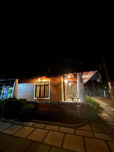 a house with lights on the front of it at night at The Munroe Vibes Inn in Munroe Island