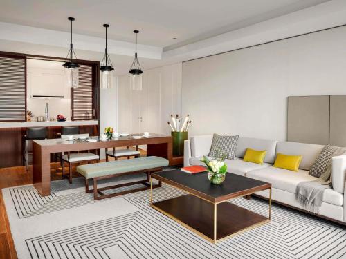 a living room with a couch and a table at Fairmont Wuhan in Wuhan