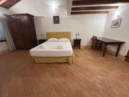 a bedroom with a bed and a table in it at BolognaRoomscom - Ca' Palazzo in Sasso Marconi