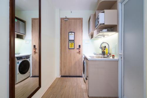 a small kitchen with a sink and a door at The Rixx Saigon Central - Next to Ben Thanh Market in Ho Chi Minh City