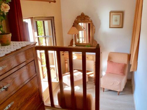 a room with a mirror and a chair and a dresser at Chambre Eglantine: Charme en Val de Loire avec Piscine et Wifi - FR-1-590-515 in Tavers