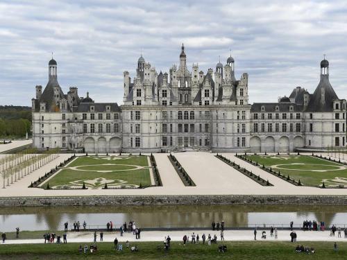 a large castle with people walking in front of it at Chambre Eglantine: Charme en Val de Loire avec Piscine et Wifi - FR-1-590-515 in Tavers