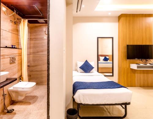 a bathroom with two beds and a toilet and a sink at Hotel Rudura Palace in Udaipur