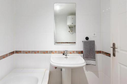a white bathroom with a sink and a mirror at Bahía Mar Apartamento in Puerto de Mazarrón